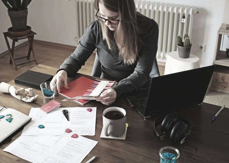 who-we-are A stylish workspace featuring a laptop and monitors displaying design software.